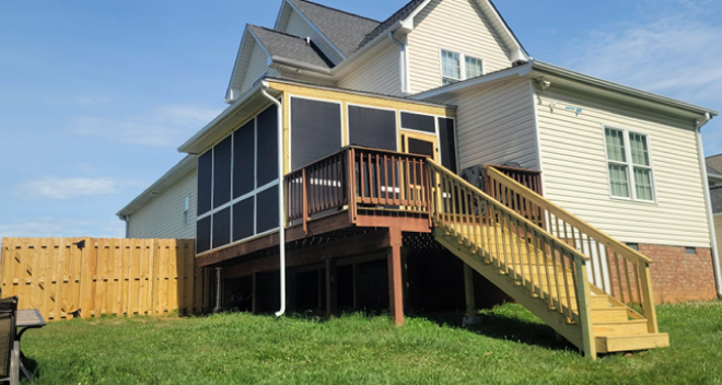 Two-story house with wooden deck and screened-in porch